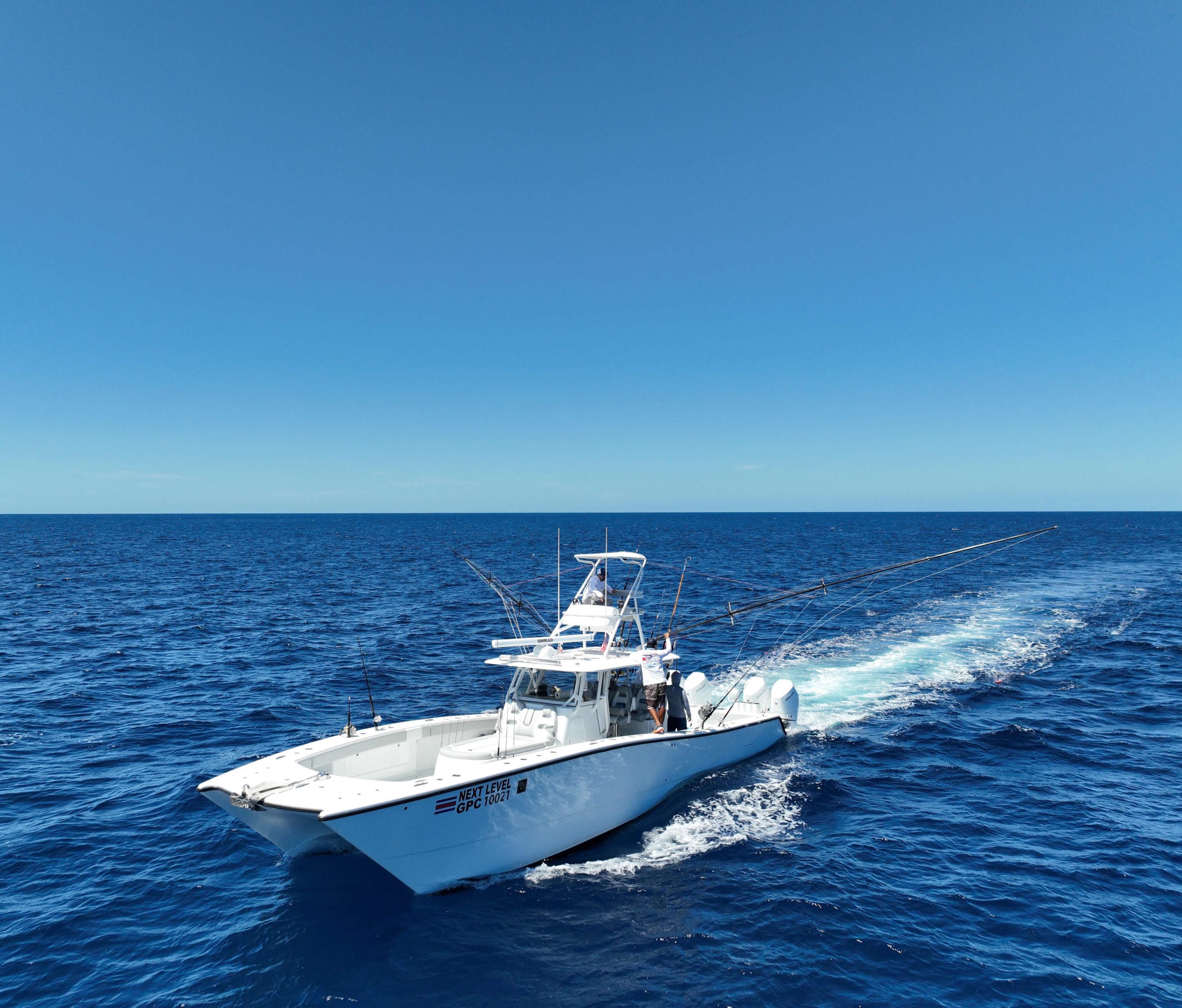 Next Level boat cruising on calm blue ocean with tuna tower